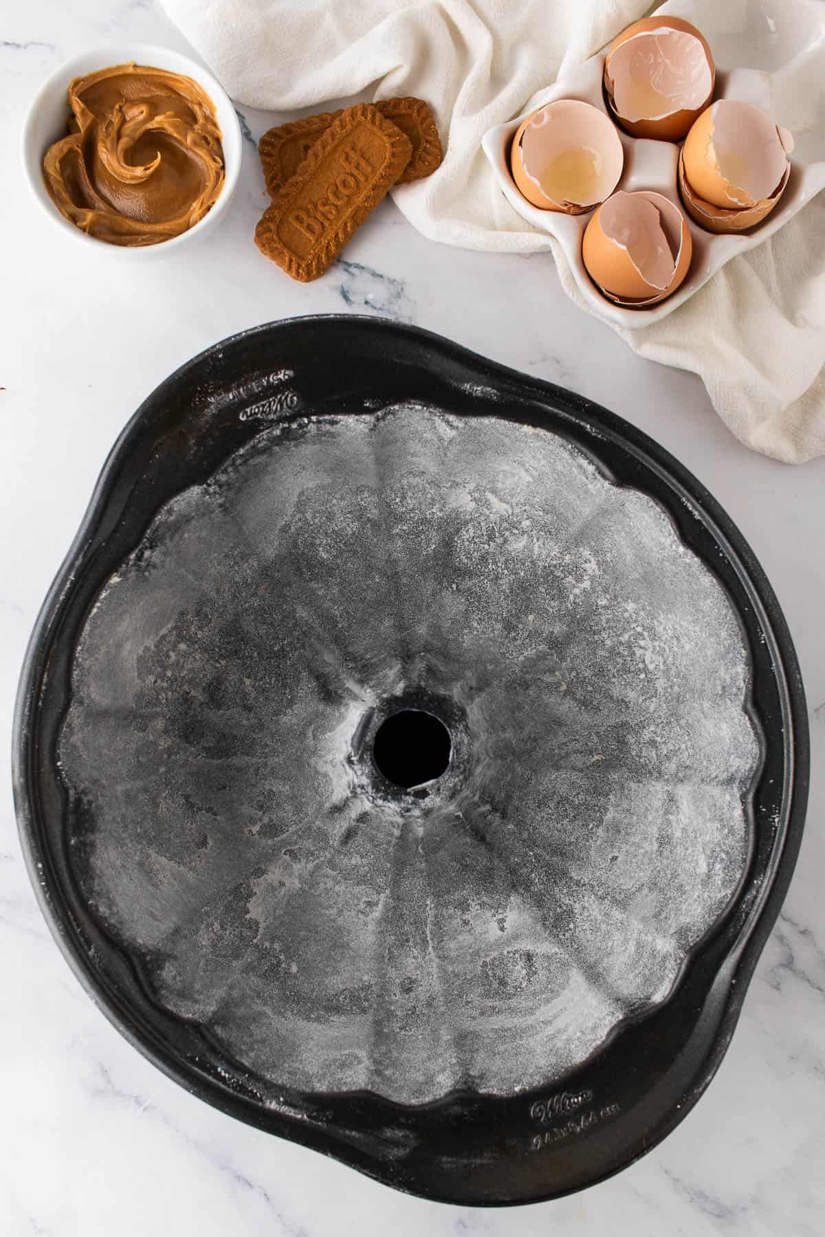 A greased and floured bundt cake pan.