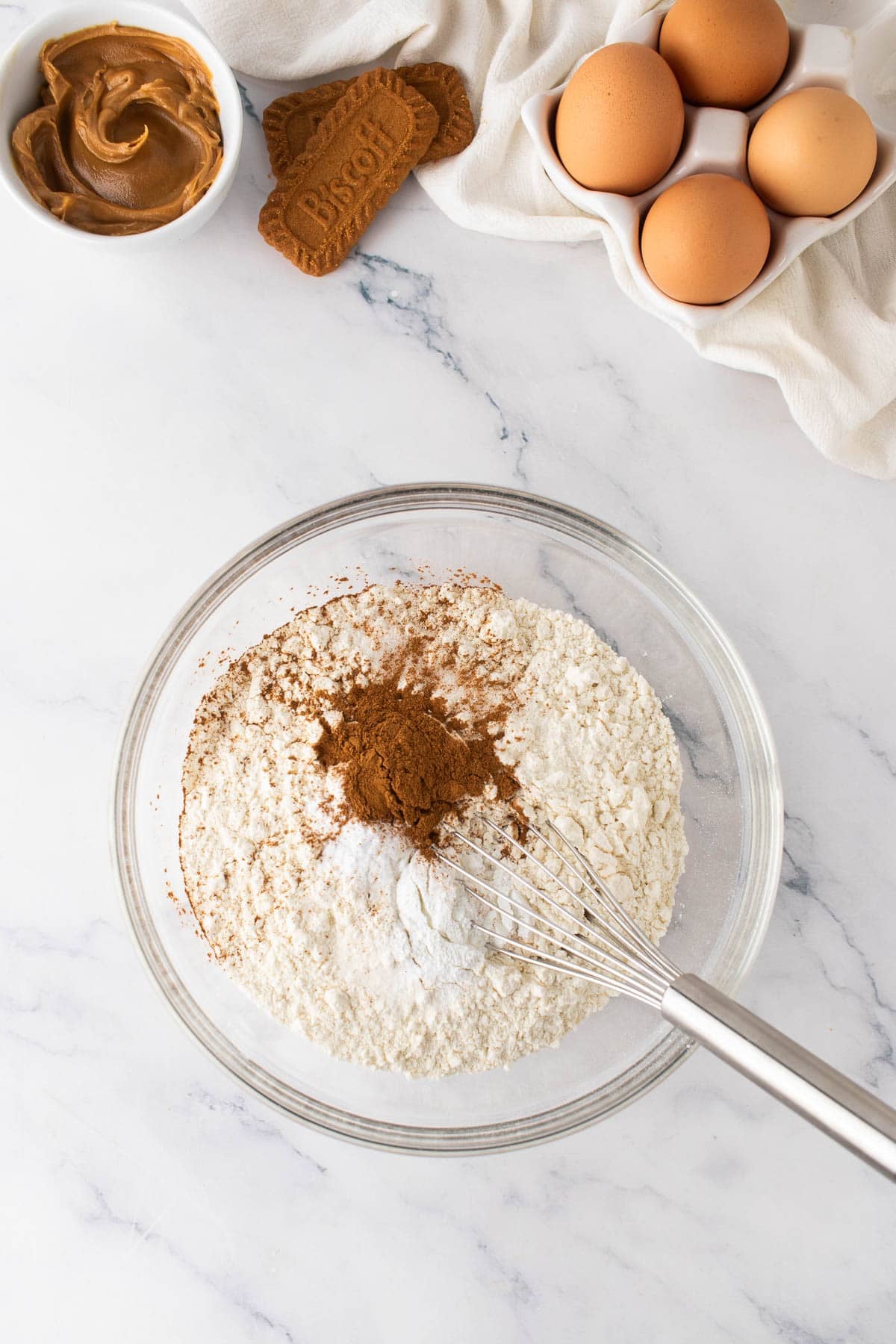 Combining dry ingredients in a mixing bowl.