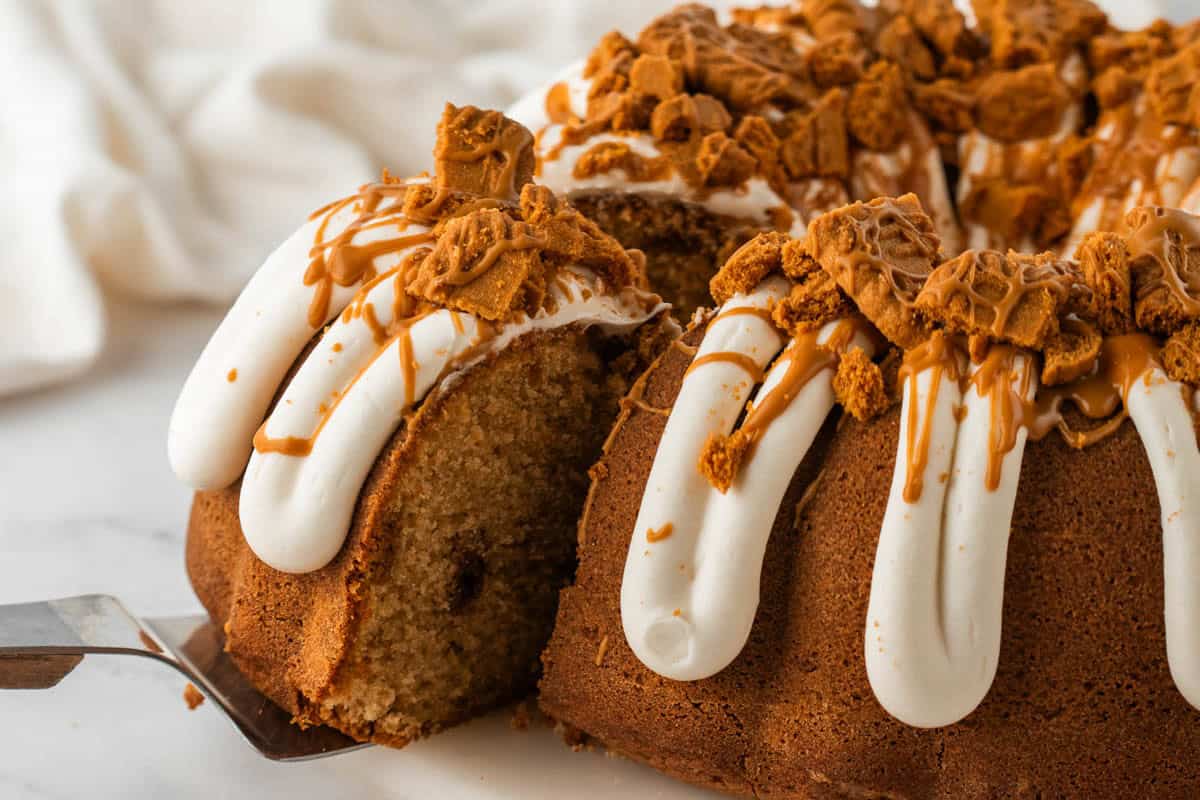 An image of a bundt cake with a slice being removed from it.