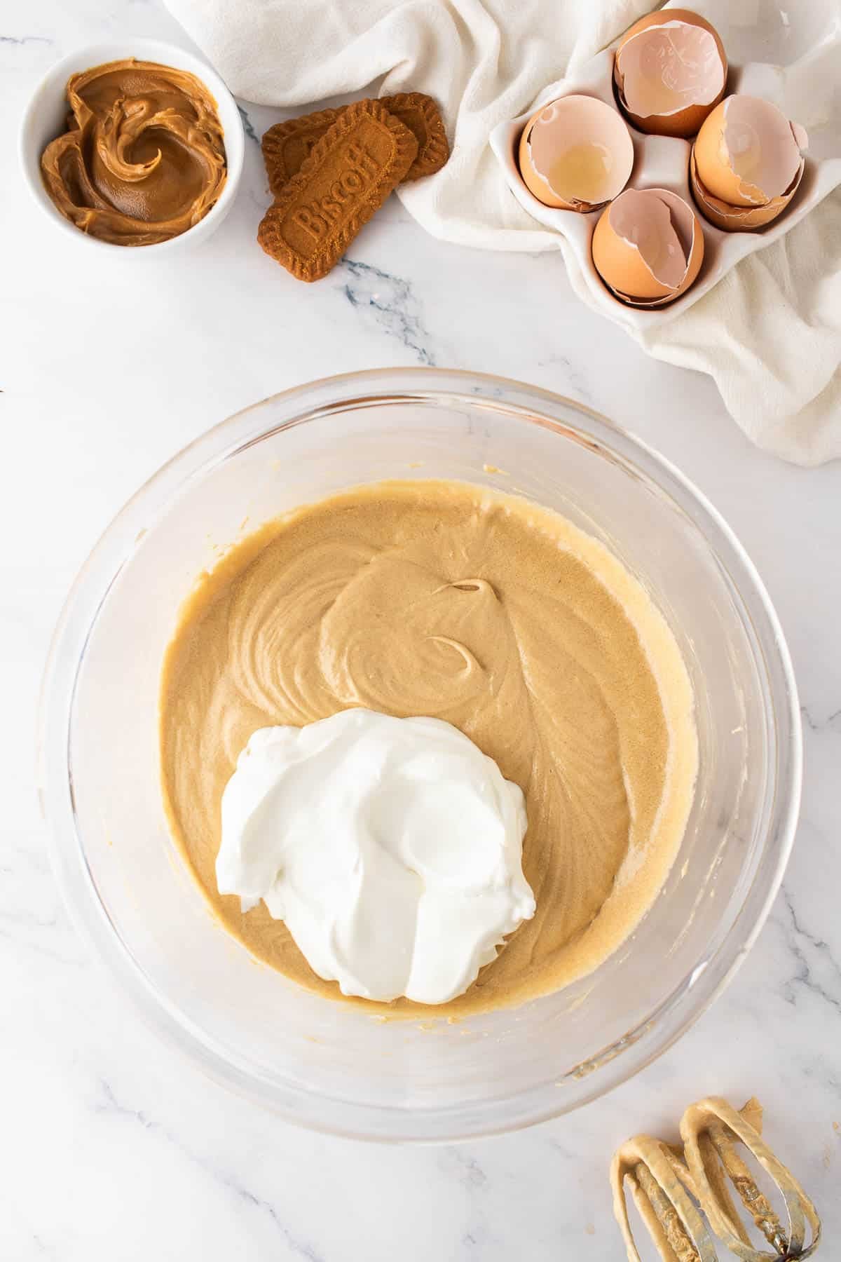Adding sour cream to cake batter.