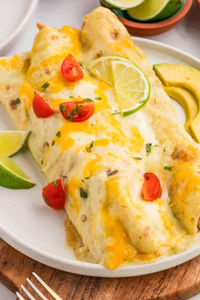 Honey lime chicken enchiladas on a white plate.