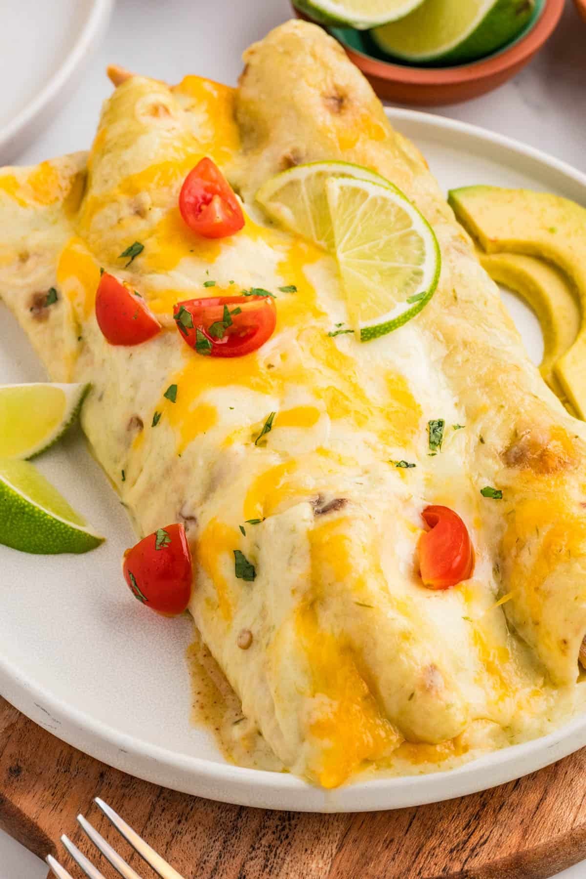 Honey lime chicken enchiladas on a white plate.