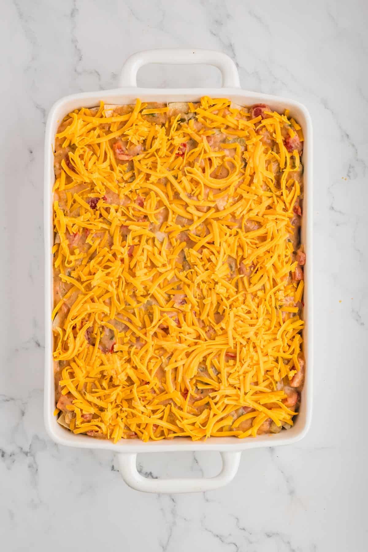 A casserole dish filled with king ranch chicken ready to go into the oven.