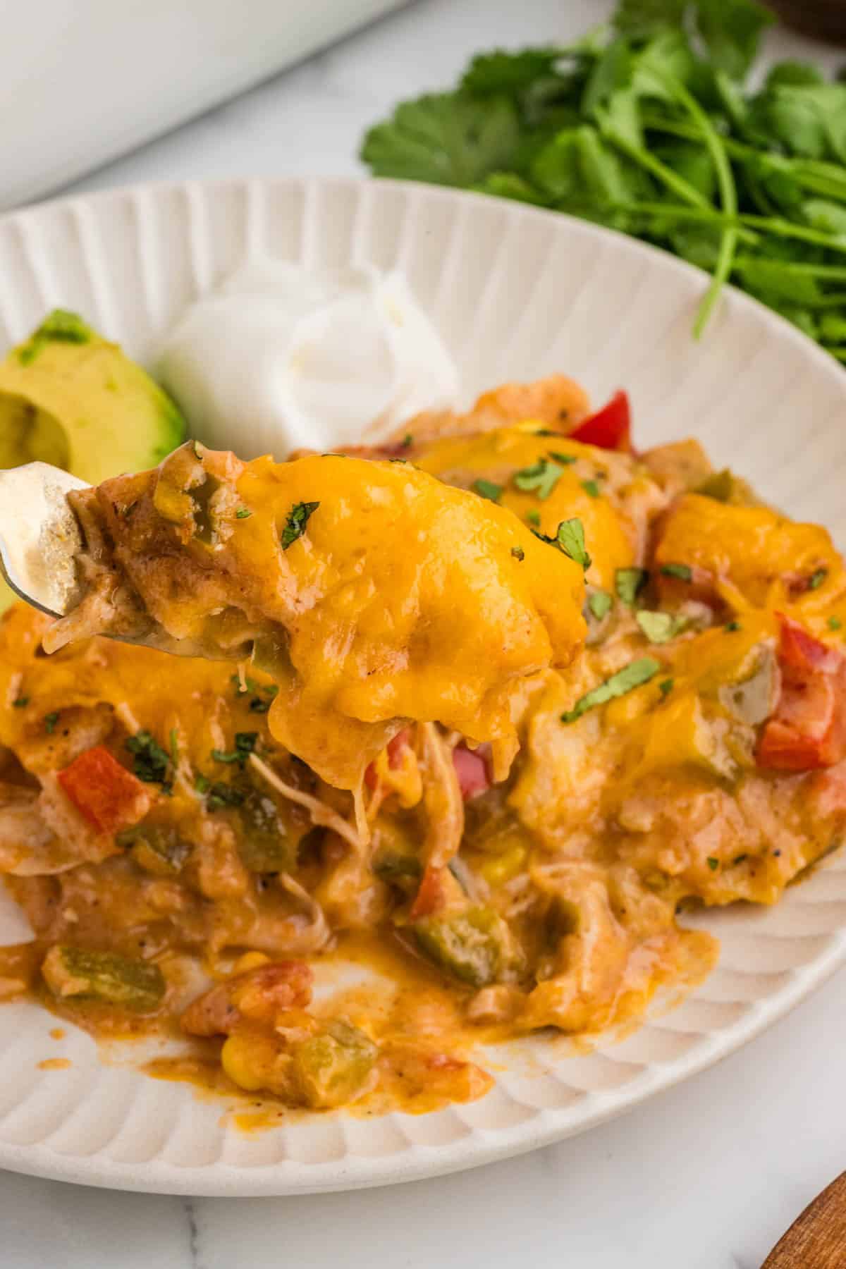 Plating a serving of king ranch chicken casserole.