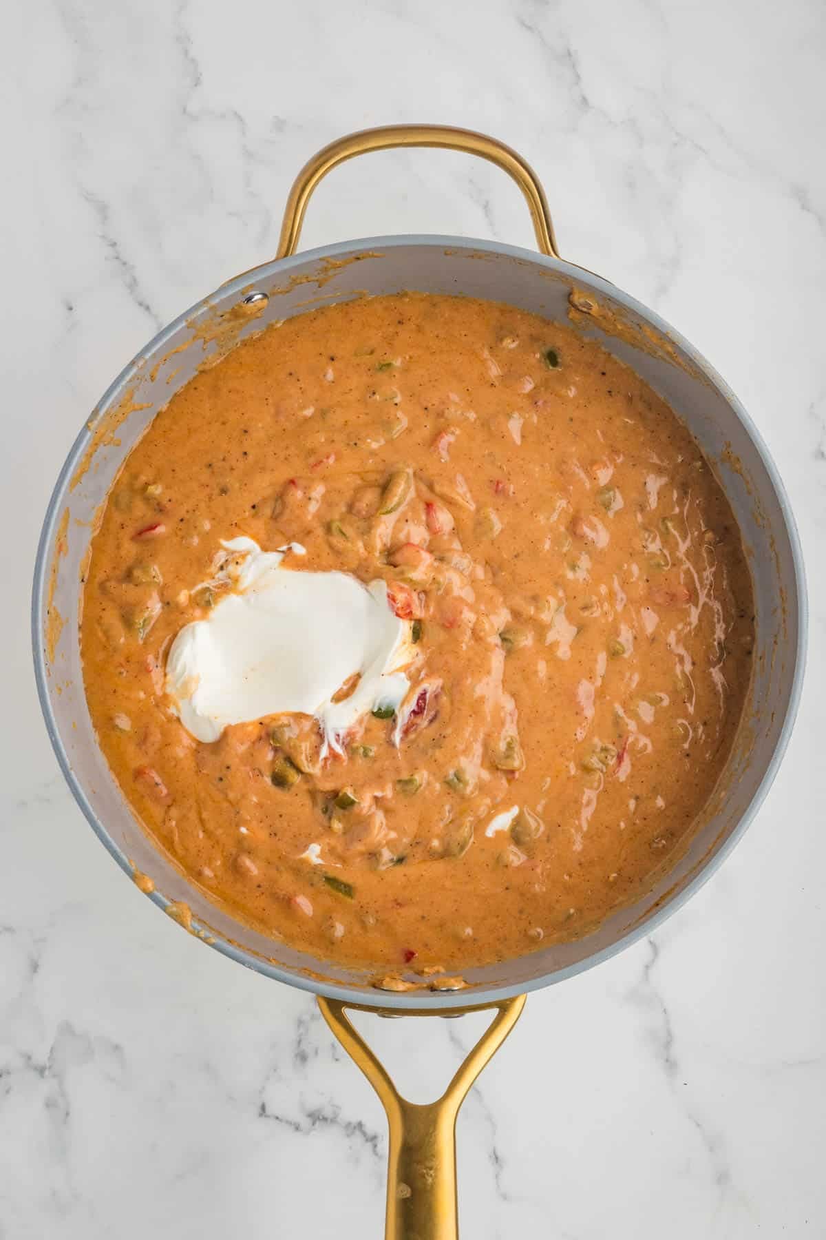 Adding sour cream to a creamy sauce.