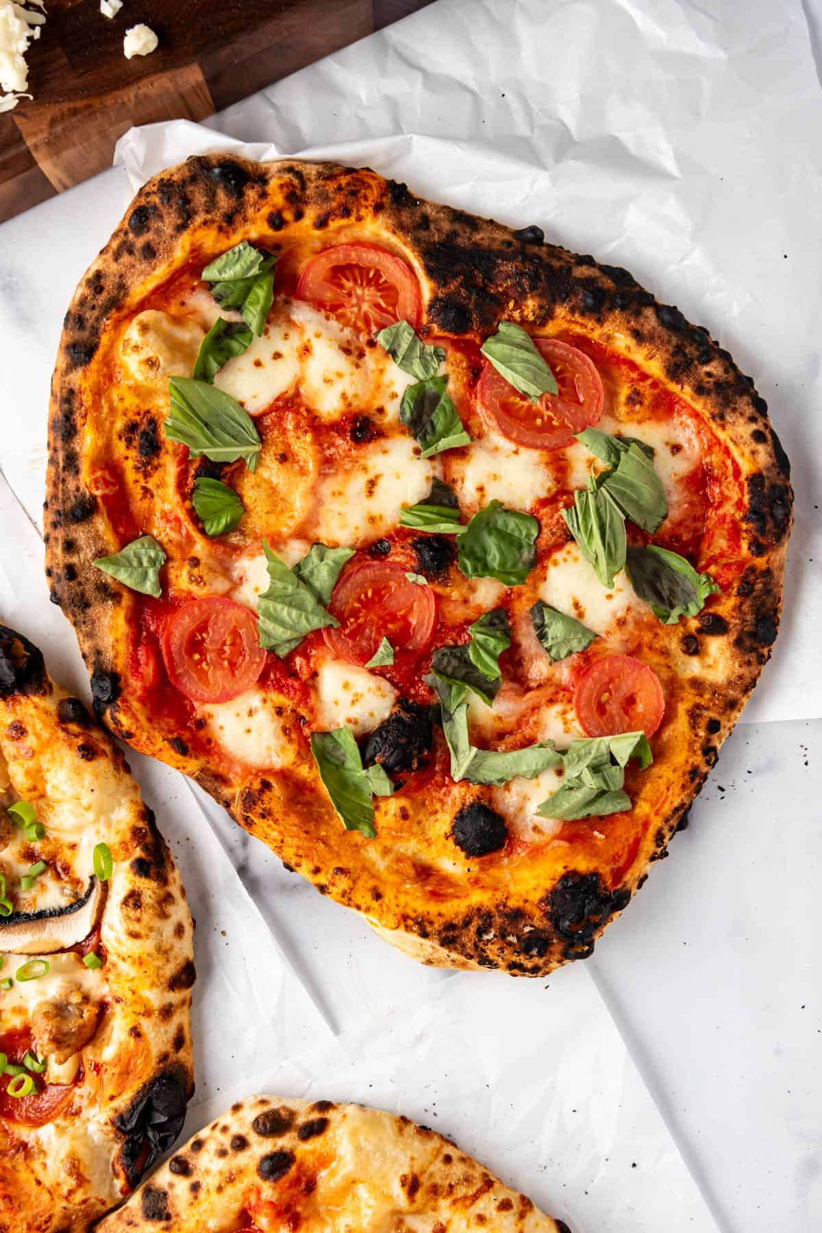 An overhead image of a sourdough margherita pizza.