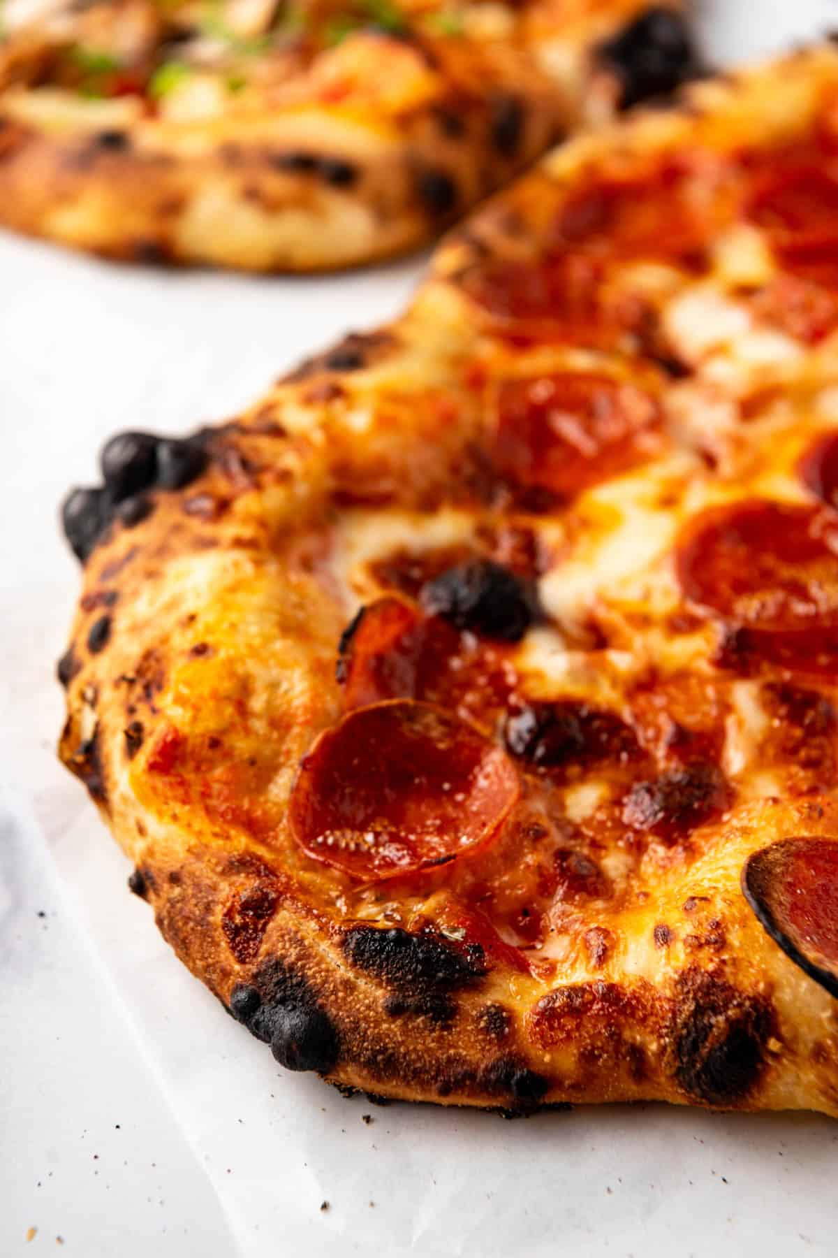 A side view of pepperoni sourdough pizza crust.