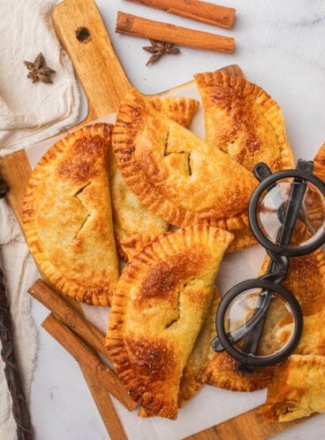 An overhead image of pumpkin pasites on a cutting board next to a pair of Harry Potter-style black glasses.