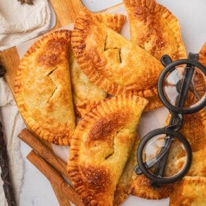 An overhead image of Harry Potter-inspired pumpkin pasties with a pair of black rimmed glasses next to them.
